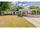 Charming single-story home featuring a covered carport and well-maintained front yard at 4906 S 87Th St, Tampa, FL 33619