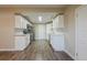 Bright kitchen featuring stainless steel appliances, white cabinets, and hardwood floors at 4906 S 87Th St, Tampa, FL 33619