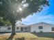 Charming single-story home with white painted exterior and a well-manicured front yard under a beautiful tree at 1207 Lorie Cir, Brandon, FL 33510