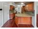 Well-lit kitchen with wood cabinets, granite countertops, tile backsplash, and modern appliances at 1207 Lorie Cir, Brandon, FL 33510