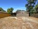 Backyard featuring a mix of gravel and grass area, along with a screened in porch at 1819 E Humphrey St, Tampa, FL 33604