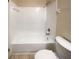 Clean bathroom with white tile shower and tub, offering a pristine and functional space for relaxation and hygiene at 1819 E Humphrey St, Tampa, FL 33604