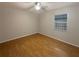 Comfortable bedroom featuring neutral walls, natural light from the bright window and wood-look flooring at 1819 E Humphrey St, Tampa, FL 33604