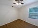 Bright bedroom with wood flooring, ceiling fan, and window bringing in natural light at 1819 E Humphrey St, Tampa, FL 33604