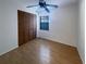 Cozy bedroom featuring hardwood floors, a ceiling fan, and a closet, creating a comfortable and private retreat at 1819 E Humphrey St, Tampa, FL 33604
