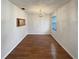 Inviting dining room with wood floors, a classic chandelier, and natural light, great for entertaining at 1819 E Humphrey St, Tampa, FL 33604