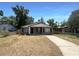 Charming home featuring neutral paint, contrasting trim, black shutters, a covered front porch, and ample natural light at 1819 E Humphrey St, Tampa, FL 33604