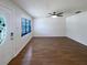 Spacious and airy living room showcasing wood flooring and a sleek ceiling fan at 1819 E Humphrey St, Tampa, FL 33604