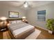 Comfortable bedroom features a large bed, a ceiling fan and natural light from the bright window at 1819 E Humphrey St, Tampa, FL 33604