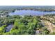Scenic aerial view showcases a waterfront property nestled near a picturesque lake amid lush greenery and a serene setting at 21940 Dupree Dr, Land O Lakes, FL 34639