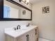 Bathroom featuring a dual vanity, undermount sinks, and decorative lighting at 21940 Dupree Dr, Land O Lakes, FL 34639