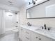 Bright bathroom featuring a double sink vanity, shower/tub combo and modern fixtures at 21940 Dupree Dr, Land O Lakes, FL 34639