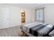 Bedroom with a queen bed, wood-look flooring, and ensuite bathroom at 21940 Dupree Dr, Land O Lakes, FL 34639