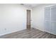 Bright bedroom features neutral walls, wood-look flooring, and a closet for storage at 21940 Dupree Dr, Land O Lakes, FL 34639