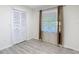 Bedroom features wood-look flooring, a window with curtains, and a closet at 21940 Dupree Dr, Land O Lakes, FL 34639