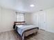 Bedroom featuring wood-look flooring, a queen bed, and a closet for storage at 21940 Dupree Dr, Land O Lakes, FL 34639