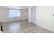 Bedroom featuring wood-look flooring, a window with curtains, and a closet at 21940 Dupree Dr, Land O Lakes, FL 34639