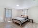 A sunlit bedroom with wood-look floors, neutral walls, and two large windows at 21940 Dupree Dr, Land O Lakes, FL 34639
