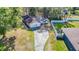 Aerial view of a cozy home with a long driveway, screened in pool, and nice backyard at 21940 Dupree Dr, Land O Lakes, FL 34639