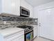 Close-up of the kitchen's stainless steel oven and microwave, with modern cabinetry at 21940 Dupree Dr, Land O Lakes, FL 34639