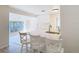 Bright and airy kitchen with white cabinets and a breakfast bar, flowing into a sunlit room at 21940 Dupree Dr, Land O Lakes, FL 34639