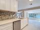 Kitchen with stainless steel dishwasher, ample counter space, and view of the living area at 21940 Dupree Dr, Land O Lakes, FL 34639