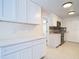 Updated kitchen featuring sleek white cabinetry, modern lighting, and tiled backsplash at 21940 Dupree Dr, Land O Lakes, FL 34639