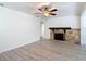 Bright living room showcasing a stone fireplace, a ceiling fan, and neutral color palettes at 21940 Dupree Dr, Land O Lakes, FL 34639