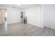 Living Room featuring wood-look flooring, a bar stool, and neutral walls at 21940 Dupree Dr, Land O Lakes, FL 34639