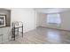 Living Room featuring wood-look flooring, a bar stool, and neutral walls at 21940 Dupree Dr, Land O Lakes, FL 34639