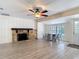 Living room with a decorative stone fireplace, tile flooring and a view of the backyard pool at 21940 Dupree Dr, Land O Lakes, FL 34639