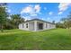 Well-maintained home with expansive backyard, showcasing the property's outdoor space and curb appeal at 3772 Bath Ln, North Port, FL 34288