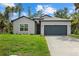 Charming single-Gathering home with a well-manicured lawn and a two-car garage at 3772 Bath Ln, North Port, FL 34288