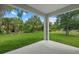 Covered outdoor patio showcasing a serene backyard and lush landscaping, perfect for outdoor living at 3772 Bath Ln, North Port, FL 34288