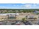 An aerial view of retail stores, including La-Z-Boy, Marshalls, with parking and lush trees in the background at 3772 Bath Ln, North Port, FL 34288