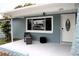 Inviting front porch with a seating area, large window, and a white front door at 3841 Chaffey Dr, New Port Richey, FL 34652