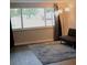 Inviting living room area with a cozy sofa, area rug, and large bright window at 3841 Chaffey Dr, New Port Richey, FL 34652