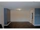 Spacious living room with minimalist decor, hardwood floors, and neutral paint at 3841 Chaffey Dr, New Port Richey, FL 34652