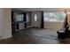 Open-concept living room with a modern TV stand, a comfortable sofa, and bright lighting at 3841 Chaffey Dr, New Port Richey, FL 34652
