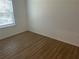 Cozy bedroom with luxury vinyl flooring and natural light from the window at 11330 Godwit Ave, Weeki Wachee, FL 34613