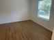 Bedroom featuring luxury vinyl flooring and a window offering natural light at 11330 Godwit Ave, Weeki Wachee, FL 34613