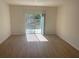 Bright living room with sliding glass doors opening to the backyard at 11330 Godwit Ave, Weeki Wachee, FL 34613