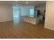 Open-concept living space with luxury vinyl flooring, flowing into the kitchen and dining area at 11330 Godwit Ave, Weeki Wachee, FL 34613