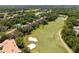 Aerial view of community featuring houses, a golf course and a pool at 1171 Clays Trl, Oldsmar, FL 34677