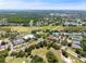 Expansive aerial view features golf course, tennis courts, pools, and beautiful landscaping at 1171 Clays Trl, Oldsmar, FL 34677
