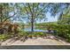 Backyard featuring a lake, landscaping and trees at 1171 Clays Trl, Oldsmar, FL 34677