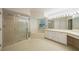 Large bathroom showcasing a glass-enclosed shower, a garden tub, and a vanity with ample lighting at 1171 Clays Trl, Oldsmar, FL 34677