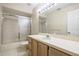 Bathroom with a tiled shower, single vanity, and large mirror at 1171 Clays Trl, Oldsmar, FL 34677