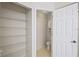 Bathroom features a linen closet with wire shelving, a toilet, and a partially open door leading to shower at 1171 Clays Trl, Oldsmar, FL 34677
