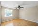 Bedroom featuring light hardwood floors, large window, and neutral paint at 1171 Clays Trl, Oldsmar, FL 34677